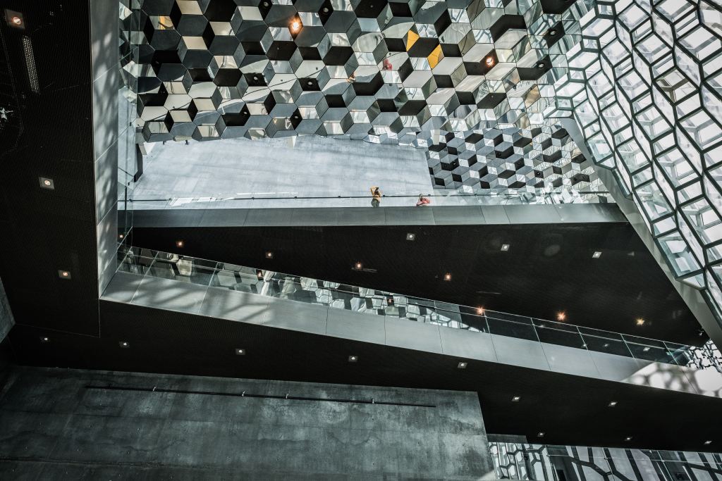 What can you do with Angular? | Interior shot of a building with multiple hard angles made up of glass cubes and walkways.